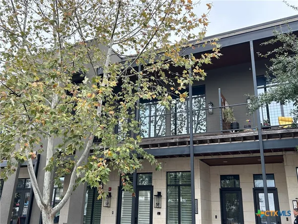view of a house with a tree