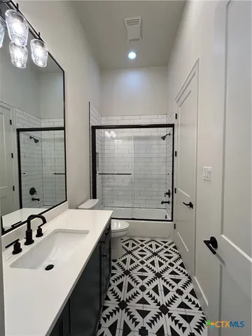 a bathroom with a sink shower and a mirror
