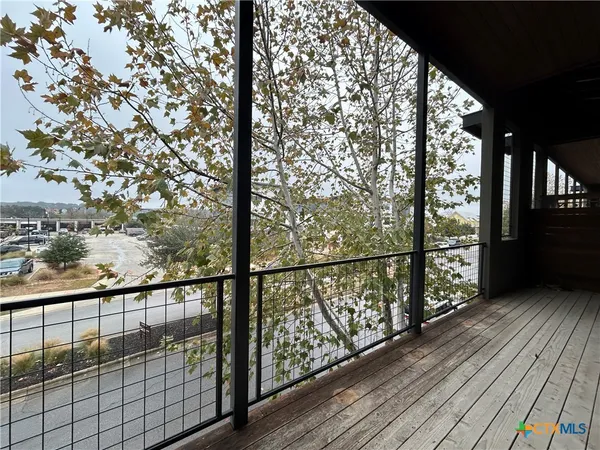 a view of balcony with wooden floor