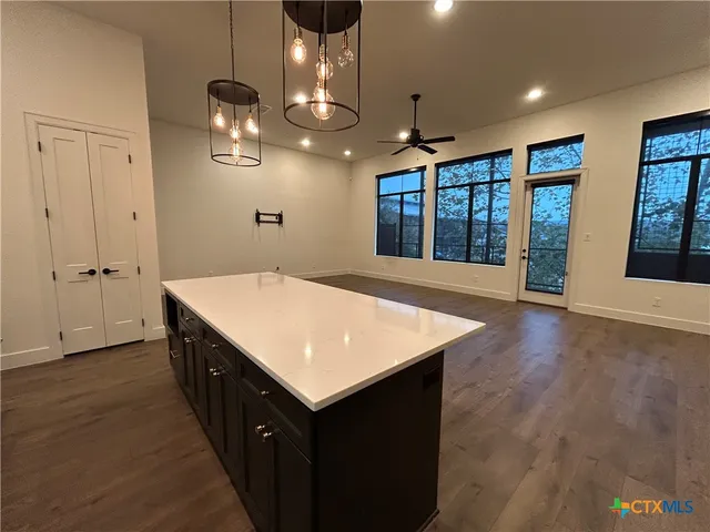 a kitchen that has a lot of cabinets in it