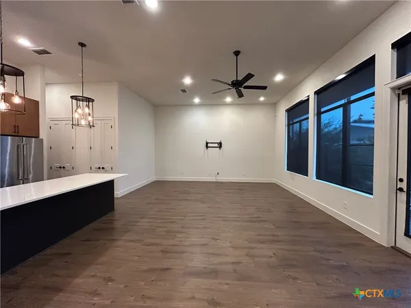 a view of a kitchen with a sink and chandelier