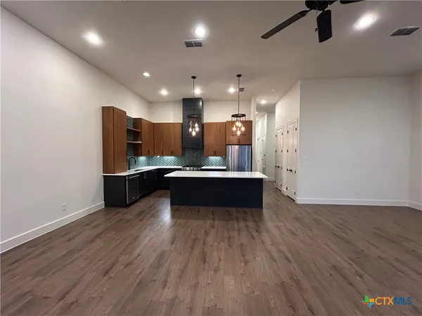 a view of kitchen with refrigerator and window