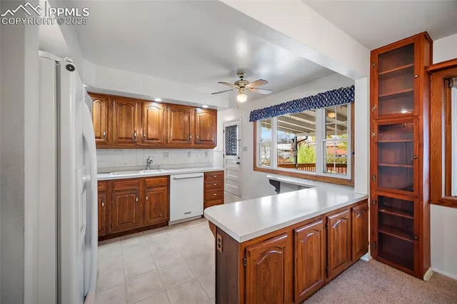 a kitchen with stainless steel appliances granite countertop a sink and dishwasher a oven with wooden cabinets