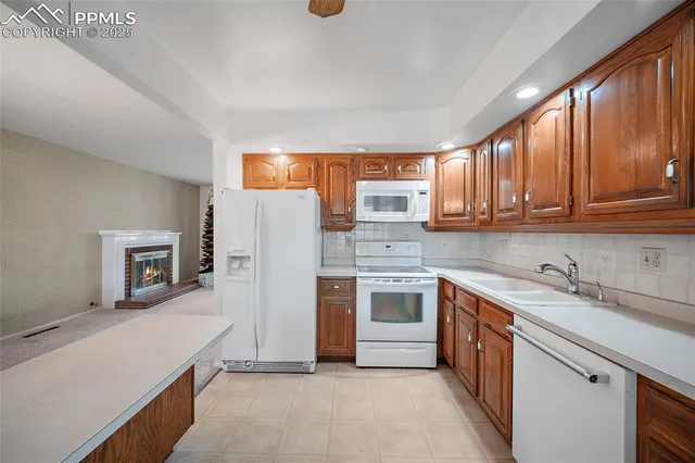 a kitchen with stainless steel appliances granite countertop a refrigerator sink and stove
