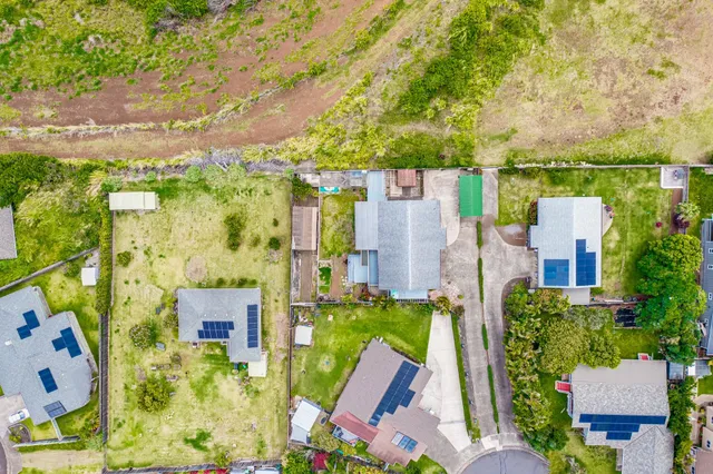 an aerial view of a house with a yard basket ball court