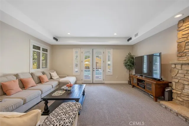 a large kitchen with stainless steel appliances granite countertop a sink and a refrigerator