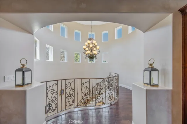 a view of a livingroom with wooden floor and furniture