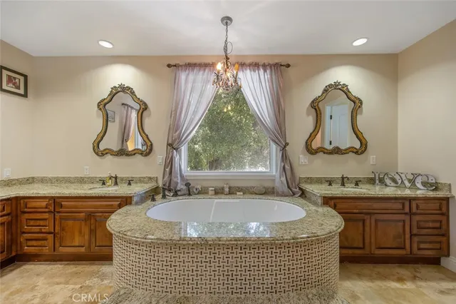 a spacious bedroom with a bed and a chandelier