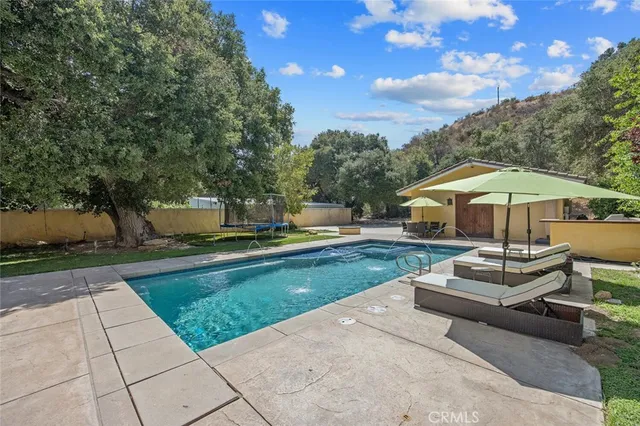 a aerial view of a house with swimming pool and mountain view