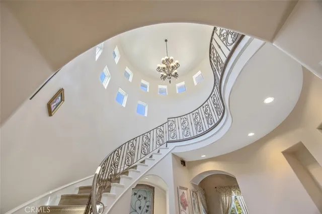 a living room with furniture a bookshelf and a large window