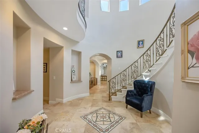 a kitchen with stainless steel appliances granite countertop a sink a stove and a refrigerator