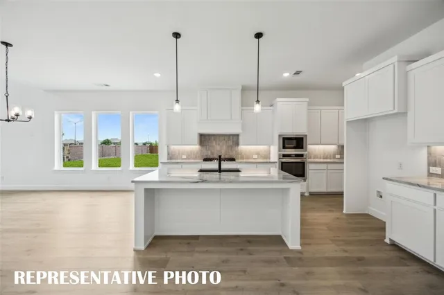 a picture of a kitchen with a white table and chairs