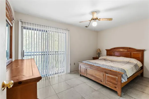 a bedroom with a bed and a dresser with mirror