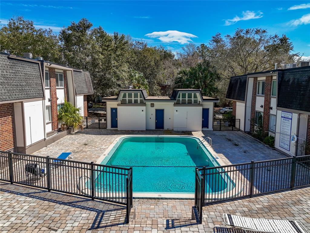 1700 Southwest 16th Court, Unit B28 Gainesville, FL 32608 - Photo 16 of 17 a view of a patio with chairs a barbeque with wooden floor and fence