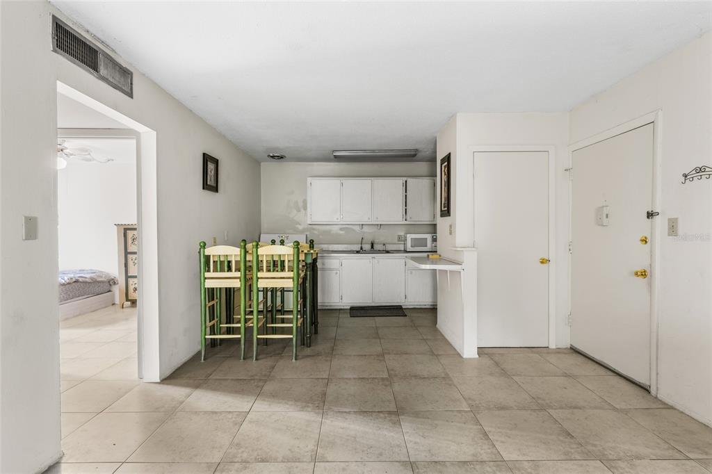 1700 Southwest 16th Court, Unit B28 Gainesville, FL 32608 - Photo 7 of 17 a kitchen with a cabinets and a refrigerator