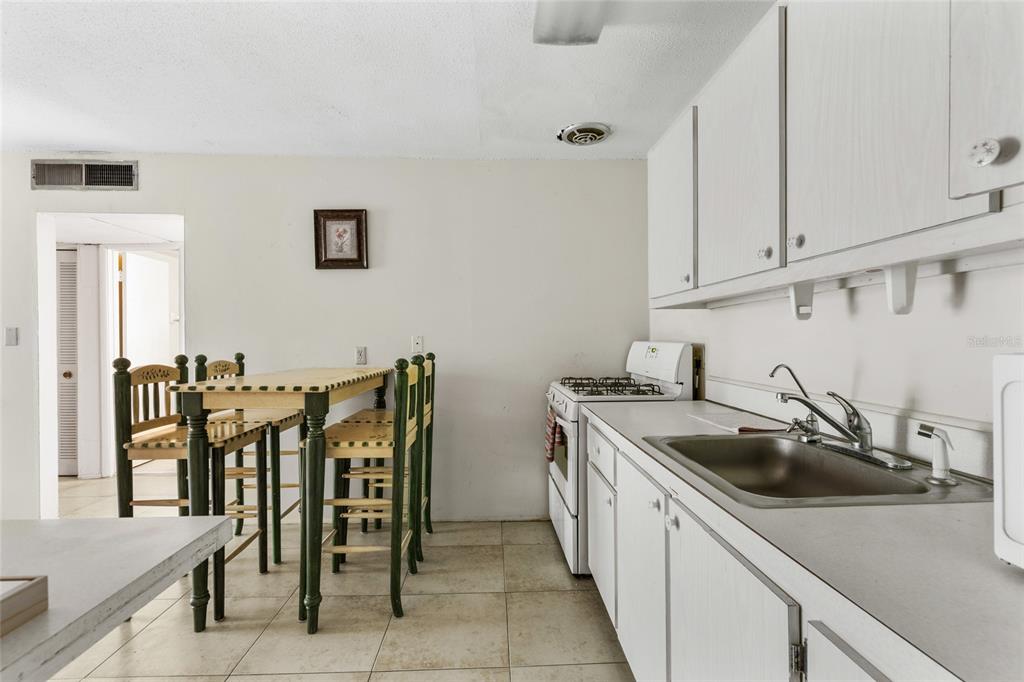 1700 Southwest 16th Court, Unit B28 Gainesville, FL 32608 - Photo 10 of 17 a kitchen that has a sink and white cabinets
