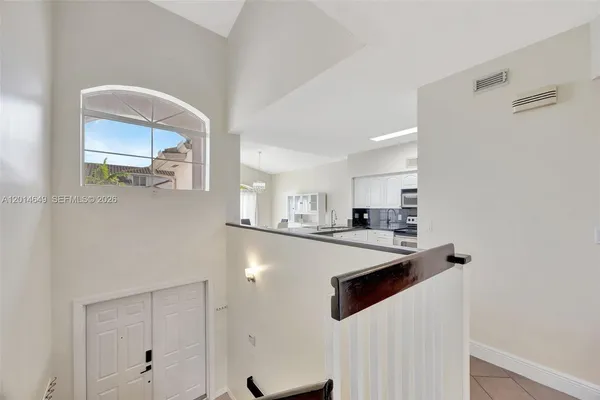 a kitchen with stainless steel appliances a refrigerator sink and white cabinets