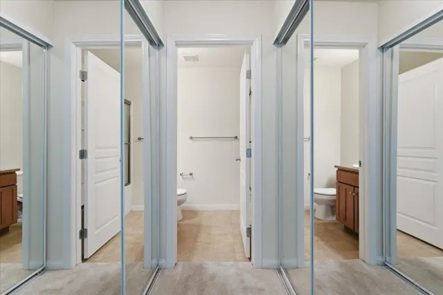 a view of bathroom with a shower and a room