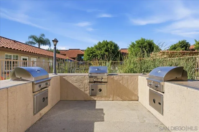 a view of a kitchen with a sink and dishwasher with a yard