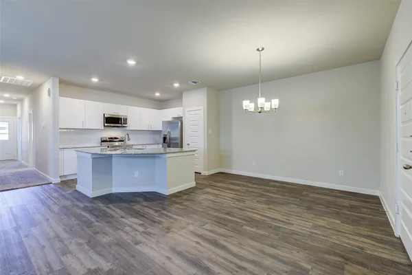 a kitchen with stainless steel appliances granite countertop a sink refrigerator and microwave
