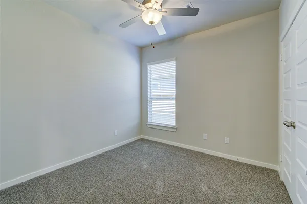 wooden floor in an empty room with a chandelier