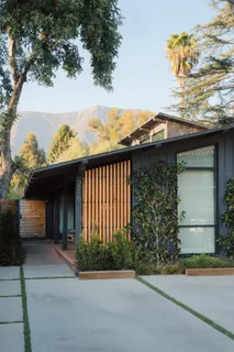 a view of a house with a window and wooden fence