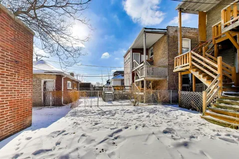 a view of a house with a yard covered in snow