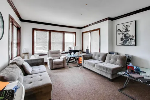 a living room with furniture and large windows