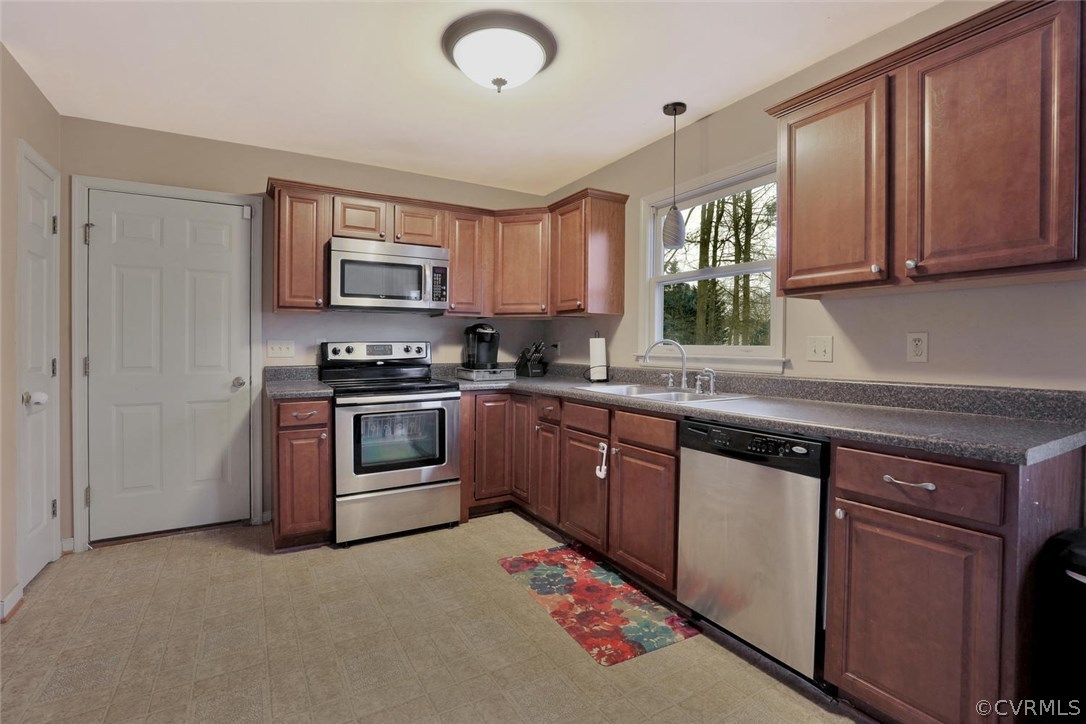 4106 Paces Ferry Road Chester, VA 23831 - Photo 4 of 23 a kitchen with stainless steel appliances granite countertop a stove sink and microwave