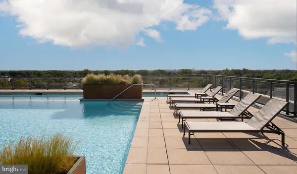 a view of a terrace with lawn chairs