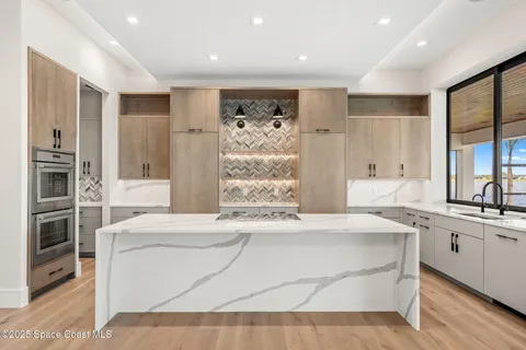 a kitchen with a sink and large window