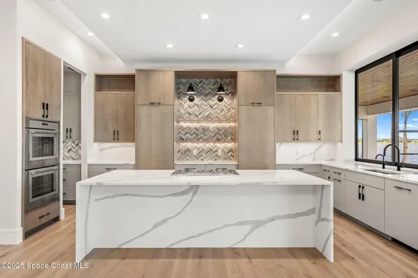 a kitchen with a sink and large window