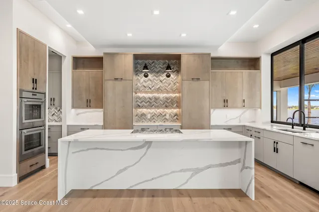 a kitchen with a sink and large window