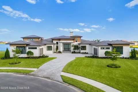 a front view of a house with a yard table and chairs