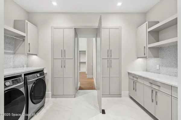 a bathroom with a double vanity sink mirror and shower