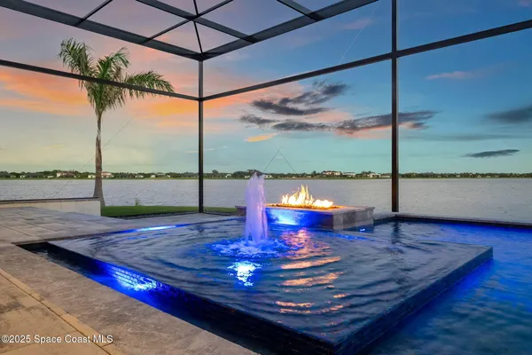 a view of a living room with a floor to ceiling window and wooden floor