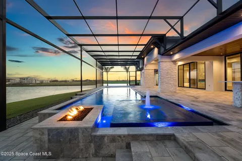 an aerial view of a house with a garden and lake view