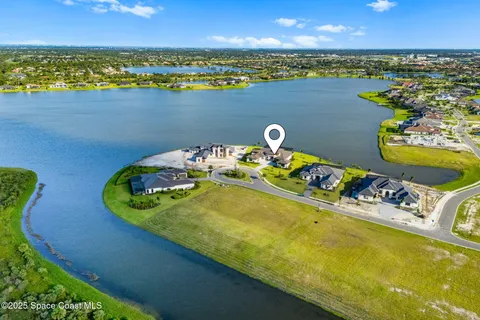 a living room with wooden floor pool table and chairs