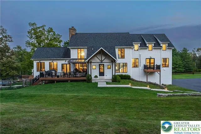 a front view of house with yard and green space