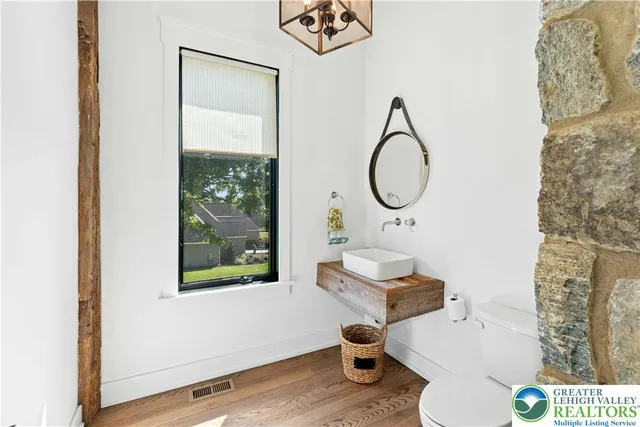 a bathroom with a toilet sink and mirror