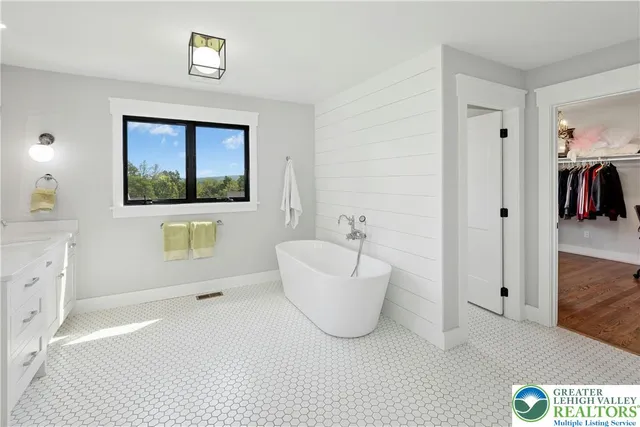 a spacious bathroom with a bathtub and a sink