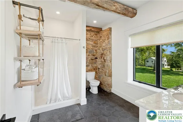 a bathroom with a toilet sink and a shower