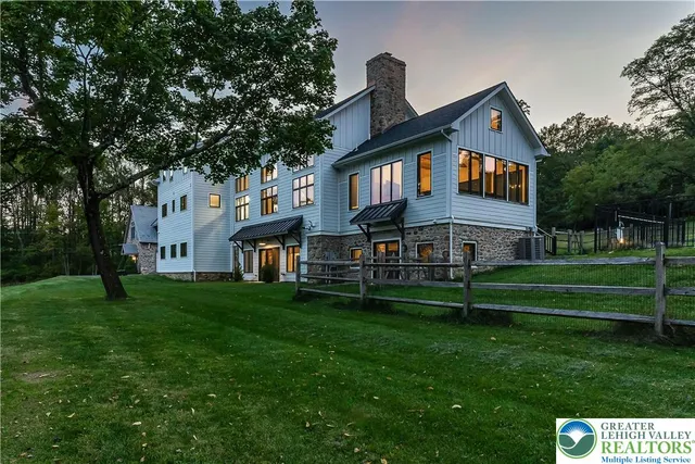 a view of backyard of house with green space