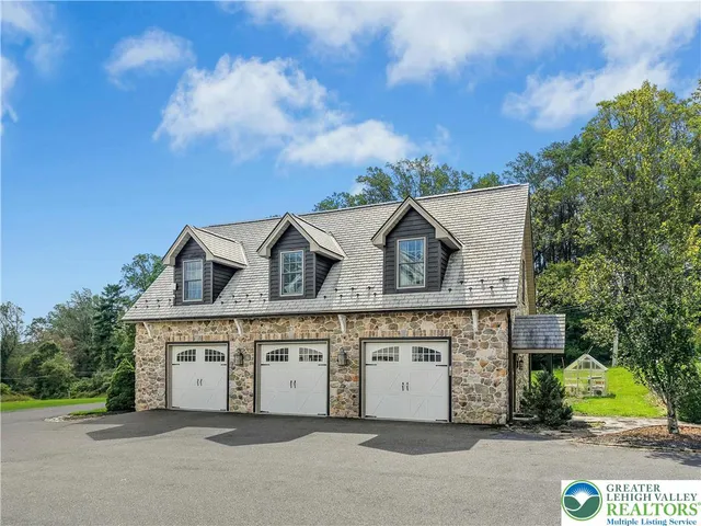 a living room with furniture kitchen view and a wooden floor