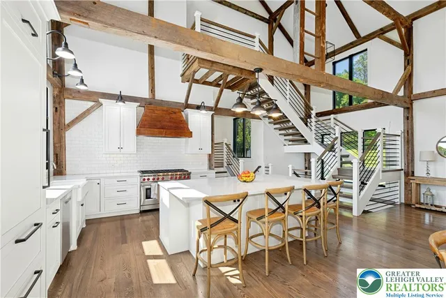 a view of a kitchen with furniture and wooden floor