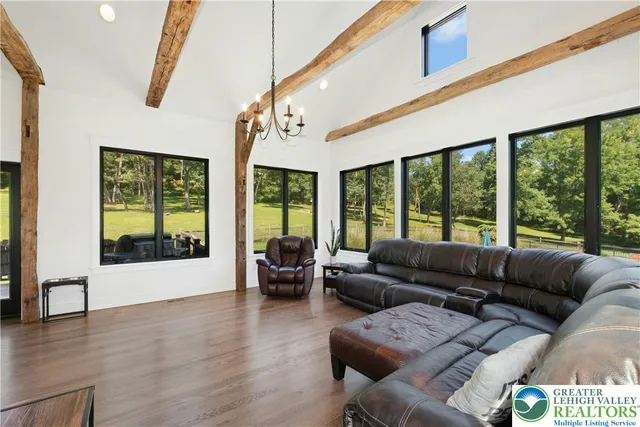 a living room with furniture and large windows