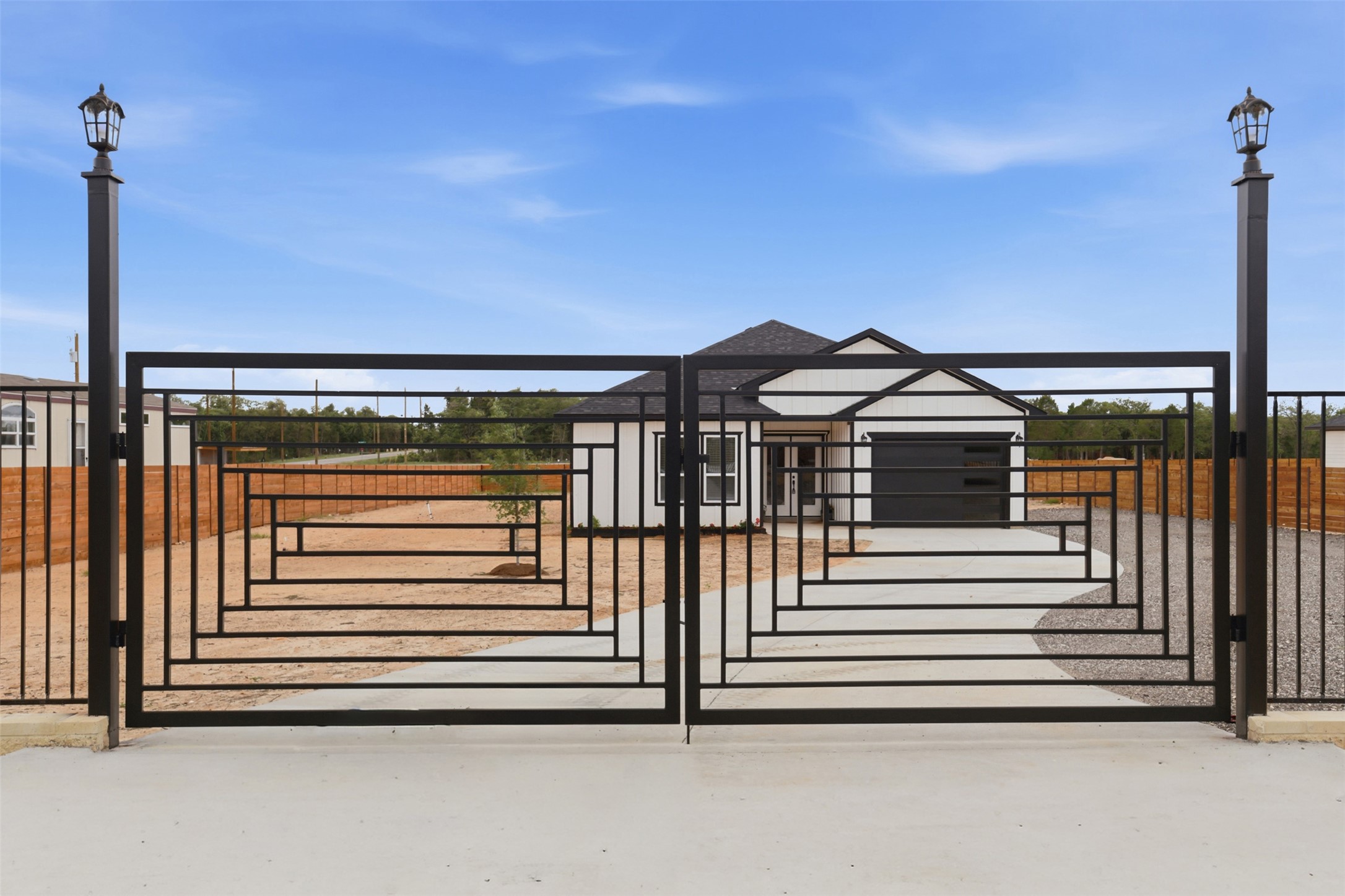 113 Los Robles Road Elgin, TX 78621 - Photo 18 of 20 Wrought iron entry gate with decorative geometric pattern