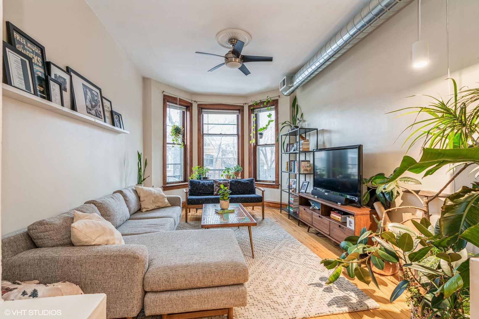 Undisclosed Address Chicago, IL 60622 - Photo 3 of 11 a living room with furniture and a flat screen tv