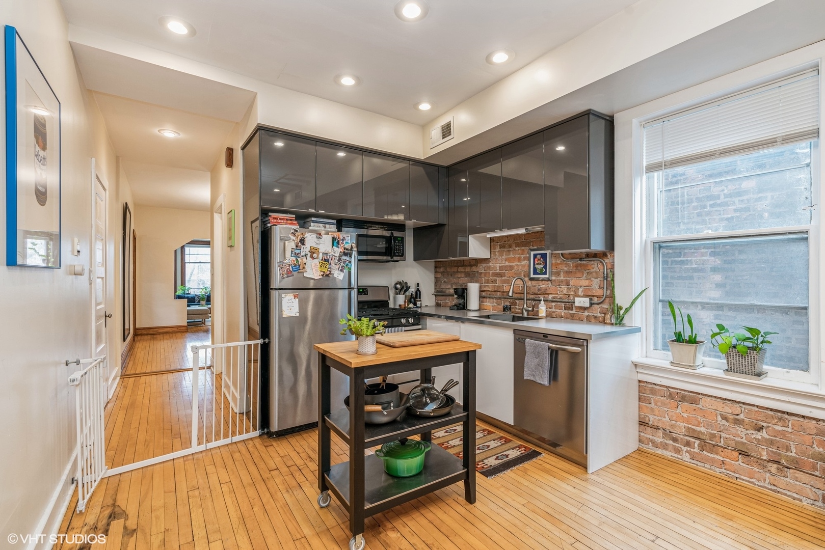Undisclosed Address Chicago, IL 60622 - Photo 4 of 11 a kitchen with stainless steel appliances granite countertop sink stove refrigerator and wooden floor