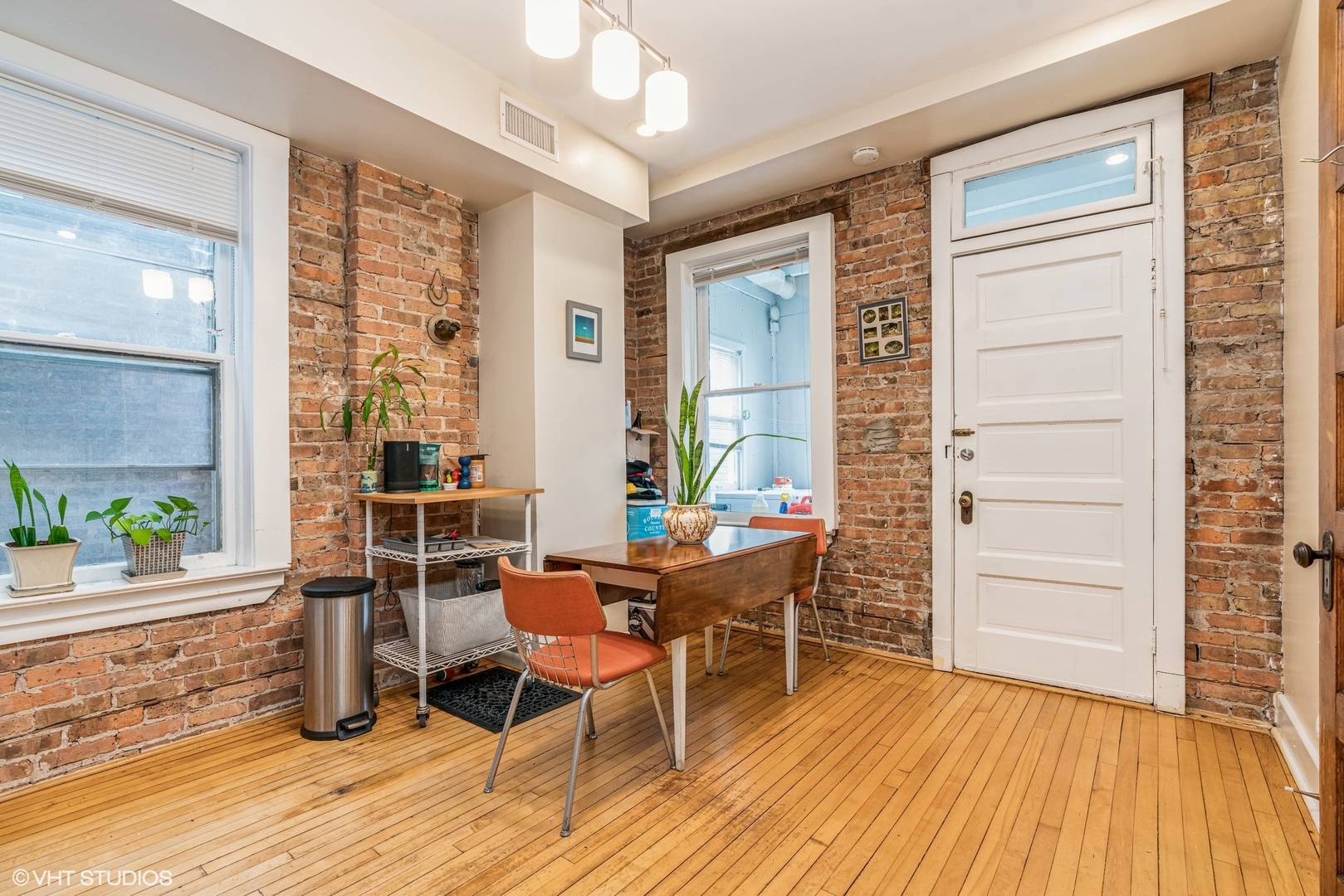 Undisclosed Address Chicago, IL 60622 - Photo 8 of 11 a dining room with a wooden table and chairs